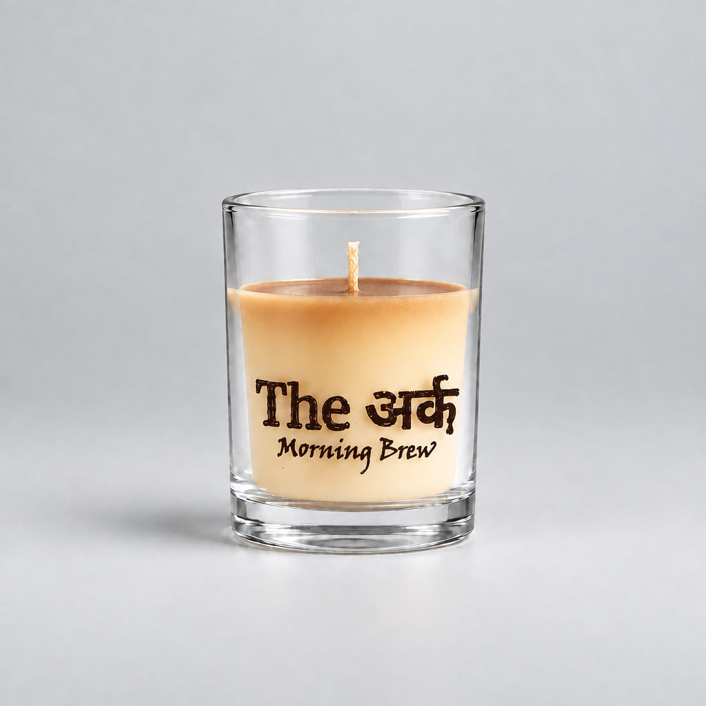 Glass candle and packaging labeled 'The Morning Brew' on an orange background