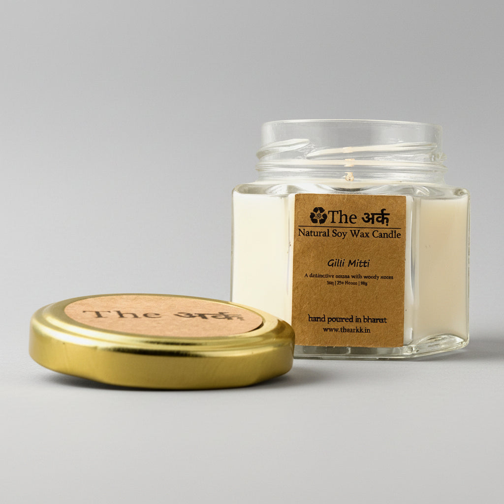 Jar of candle with gold lid on a beige background